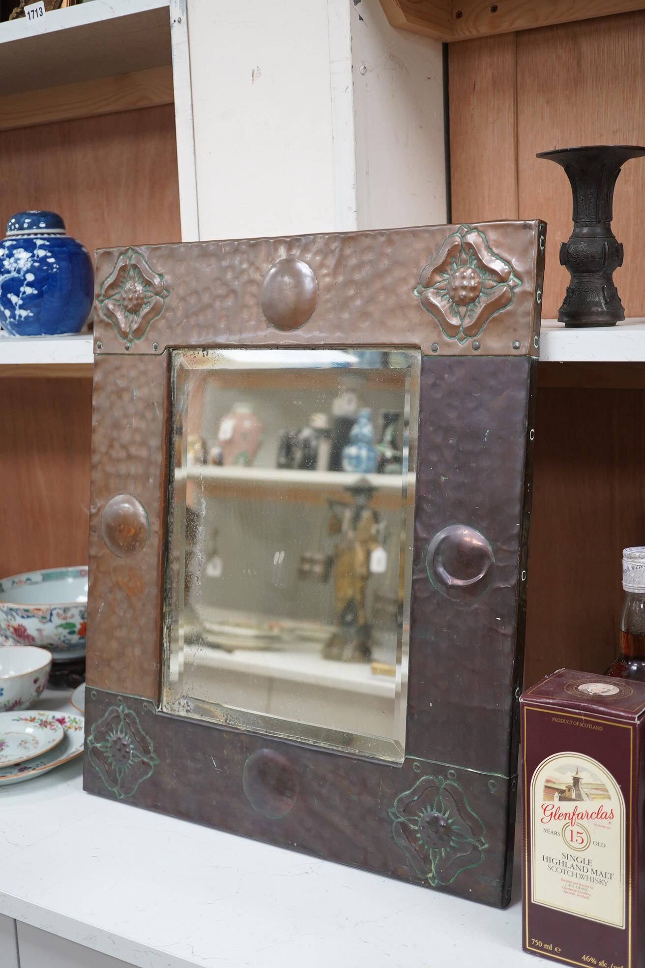 An Arts & Crafts style early 20th century copper framed mirror, 58 x 50cm. Condition - fair to good